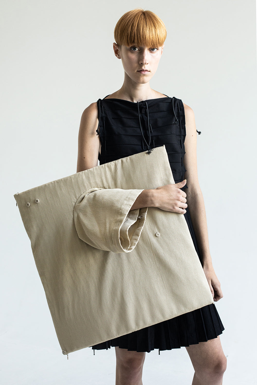 DZHUS Cardboard as a bag worn on a hand