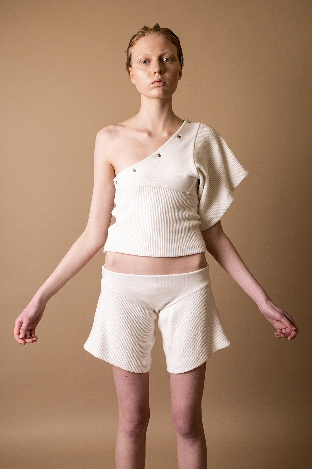 DZHUS Duplicate in white as a one-shoulder shirt and shorts