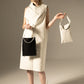 DZUS Substitute as a white dress with two bags