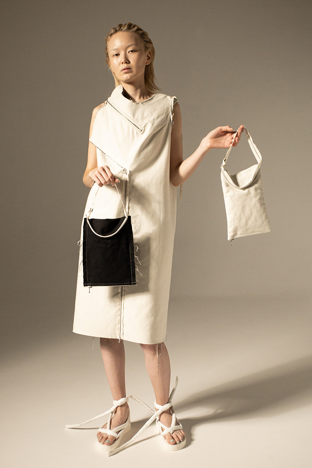 DZUS Substitute as a white dress with two bags