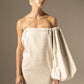 DZHUS Uni as a white dress with one shoulder down